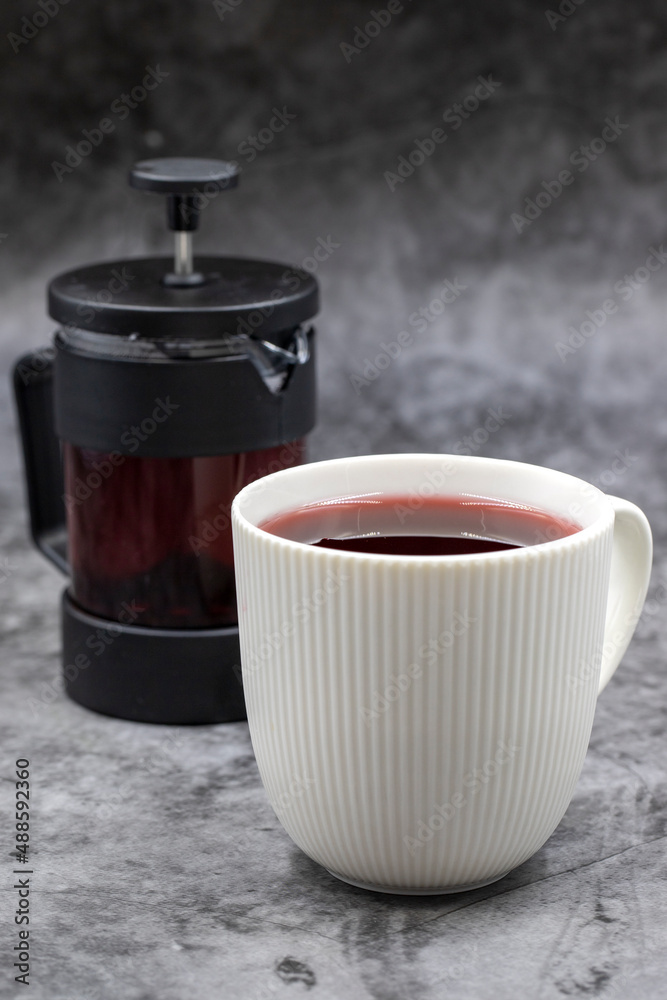 Apple Tea (Hibiscus tea) on dark background. Medicinal asian herbal tea. Fruit tea blended with Hibiscus, Rosehip, Orange Peel, Lemon Peel and Apple Flavor
