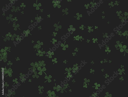 Green shamrock on black background falling from the sky