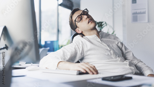 Tired office worker sleeping in the office