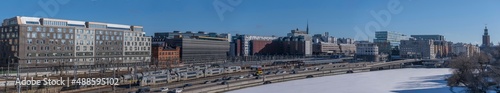 Panorama, railway, central station, turn points, catenary, electric poles and tunnels. Train, office, station, hotel buildings. Icy canal Karlbergskanalen, in Stockholm