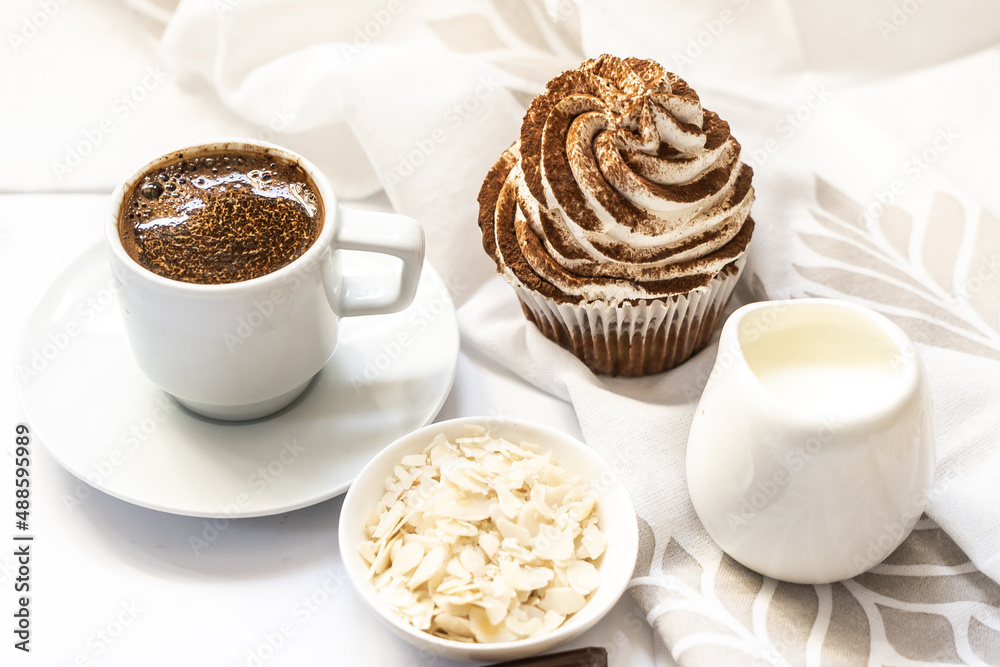 Dark chocolate and cocoa chocolate cupcakes with a cup of hot black coffee Dark chocolate and cocoa chocolate cupcakes with a cup of hot black coffee