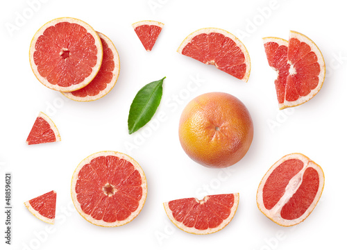 A set of whole and sliced grapefruit with leaves isolated on white background. Top view.