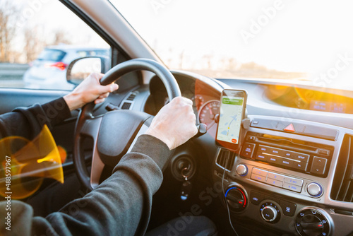 Gps car map system. Global positioning system on smartphone screen in auto car on travel road. Navigation auto location system app. © Maksym