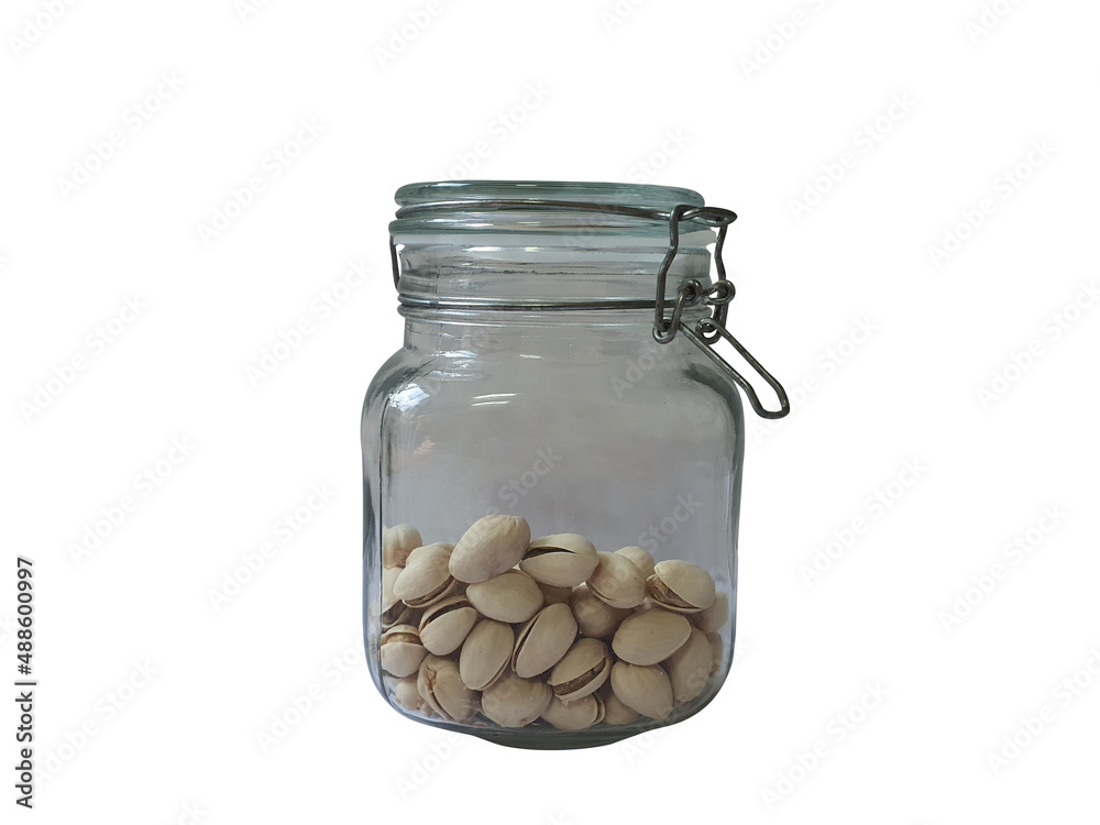 Pistachios are put in an airtight glass jar to preserve food. And can preserve food to extend the life of food on a white background. Pistachios are put in an airtight glass jar to preserve food. And can preserve food to extend the life of food on a white background.