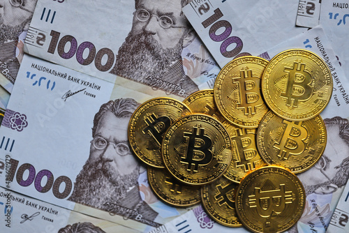 Ukrainian money with Cryptocurrency Coins.Bitcoin BTC, Ukrainian hryvnia, Tether USDT cryptocurrency physical coin photo