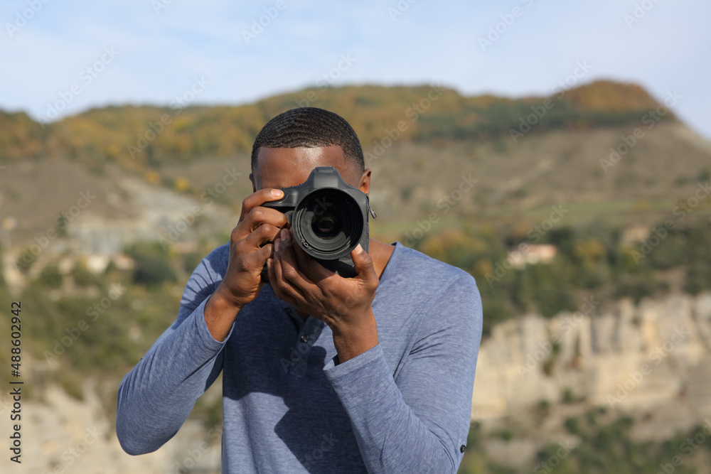 Man with black skin takes photos with dslr camera Man with black skin takes photos with dslr camera