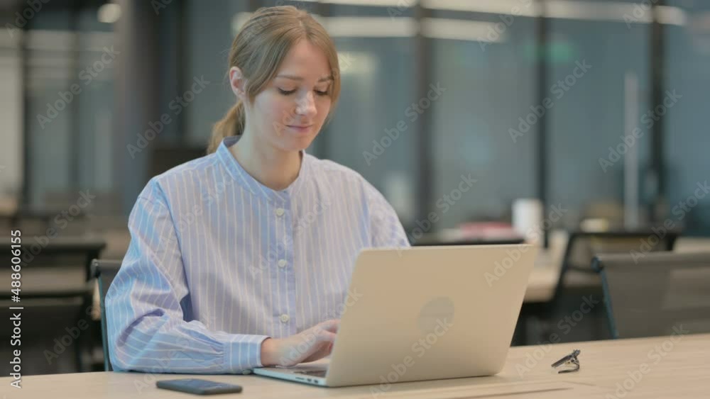 Young Woman Working on Laptop in Office Young Woman Working on Laptop in Office