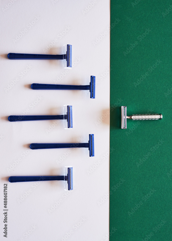 A comparison of plastic and eco-friendly razors on a green flat lay A comparison of plastic and eco-friendly razors on a green flat lay