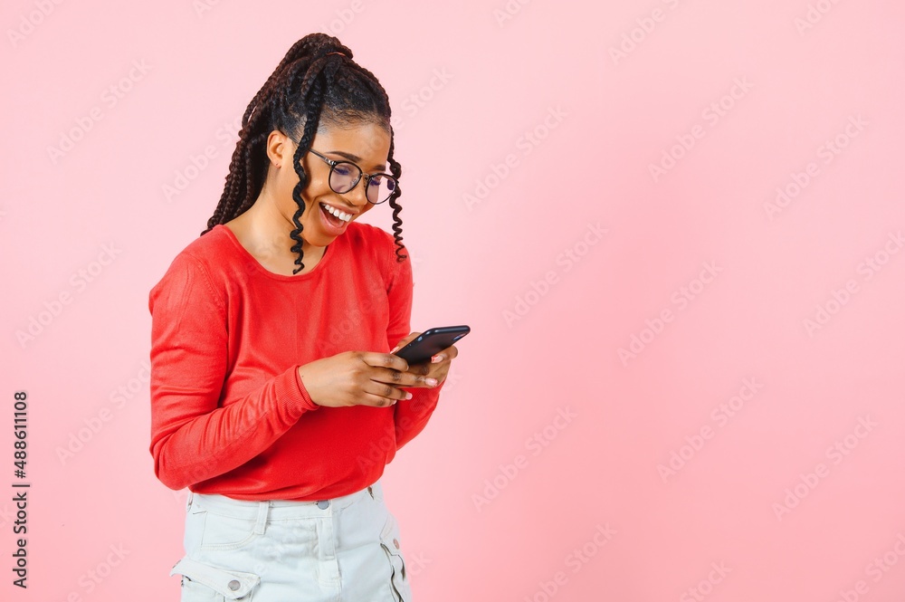 Beauty happy african woman looking at phone and writing message Beauty happy african woman looking at phone and writing message