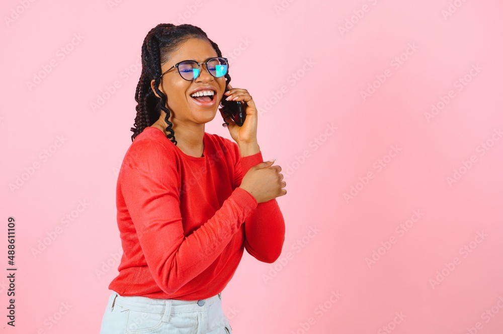Obraz premium Portrait of pretty cheerful girl talking on phone discussing news cellular isolated over pink pastel color background