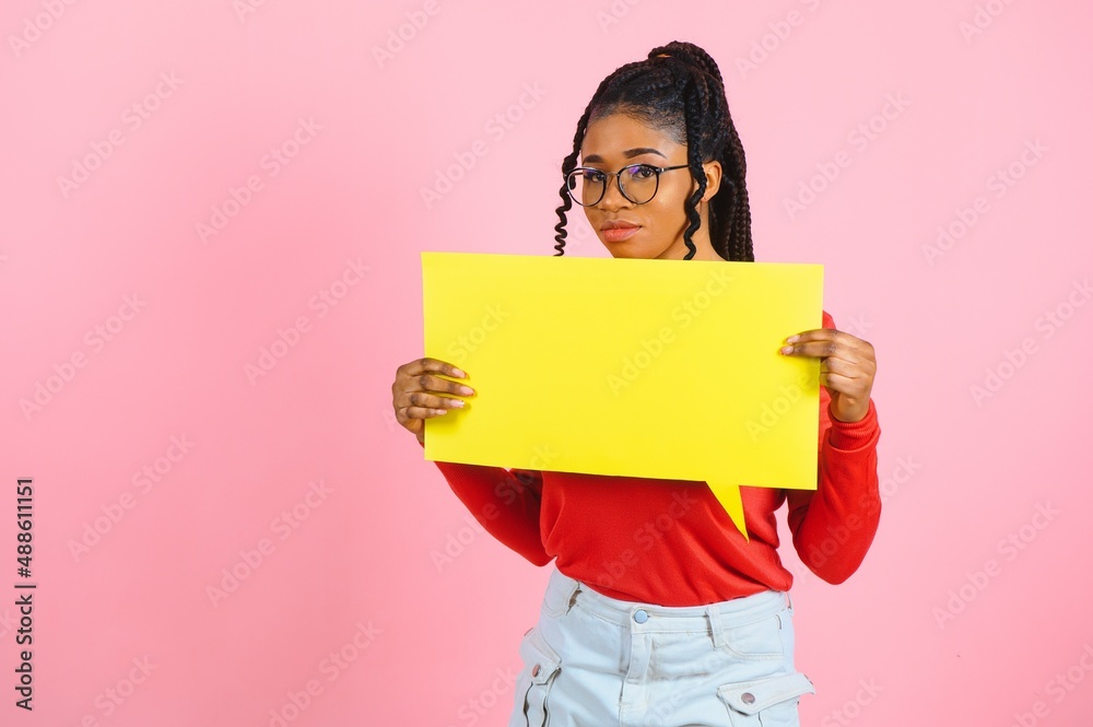 Place For Text. Happy black woman pointing at white advertisement board isolated over pink wall, copyspace Place For Text. Happy black woman pointing at white advertisement board isolated over pink wall, copyspace