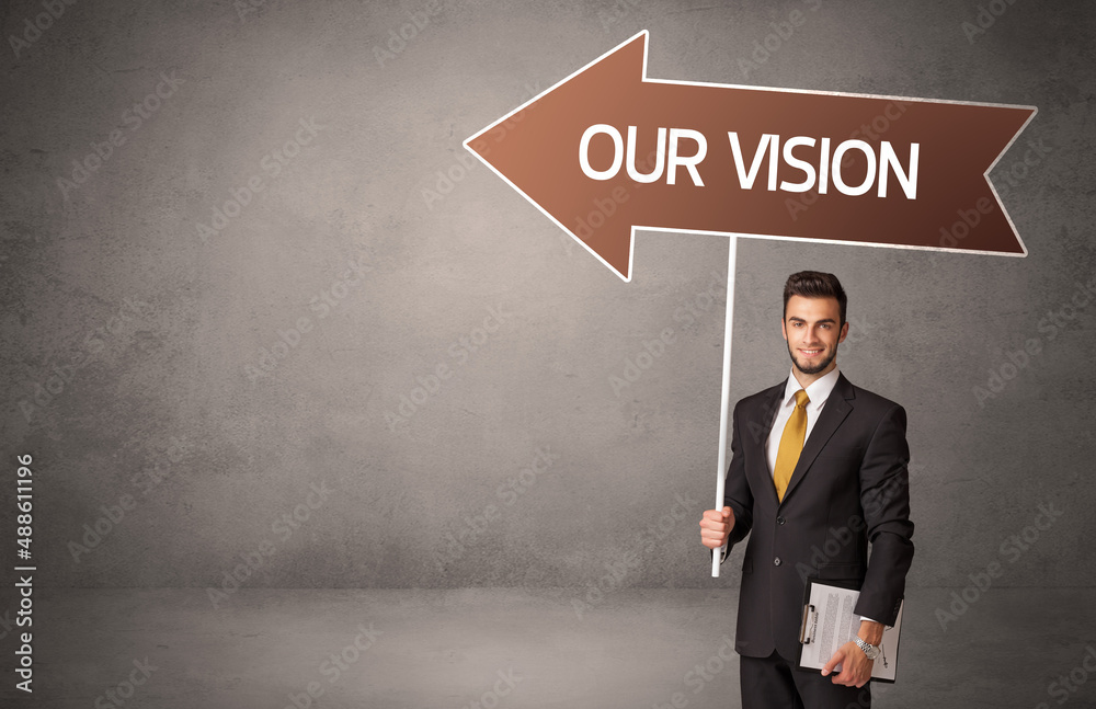 Fototapeta premium Young business person in casual holding road sign