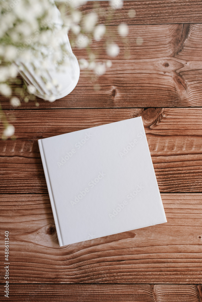 hardcover white book mock up on wooden table hardcover white book mock up on wooden table