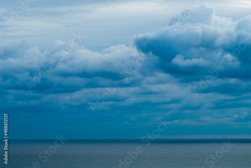 Panoramic view of bright blue sea, blue sky with fluffy white clouds