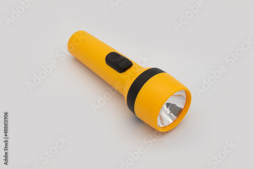 yellow flashlight isolated on a white background using as reserved emergency power