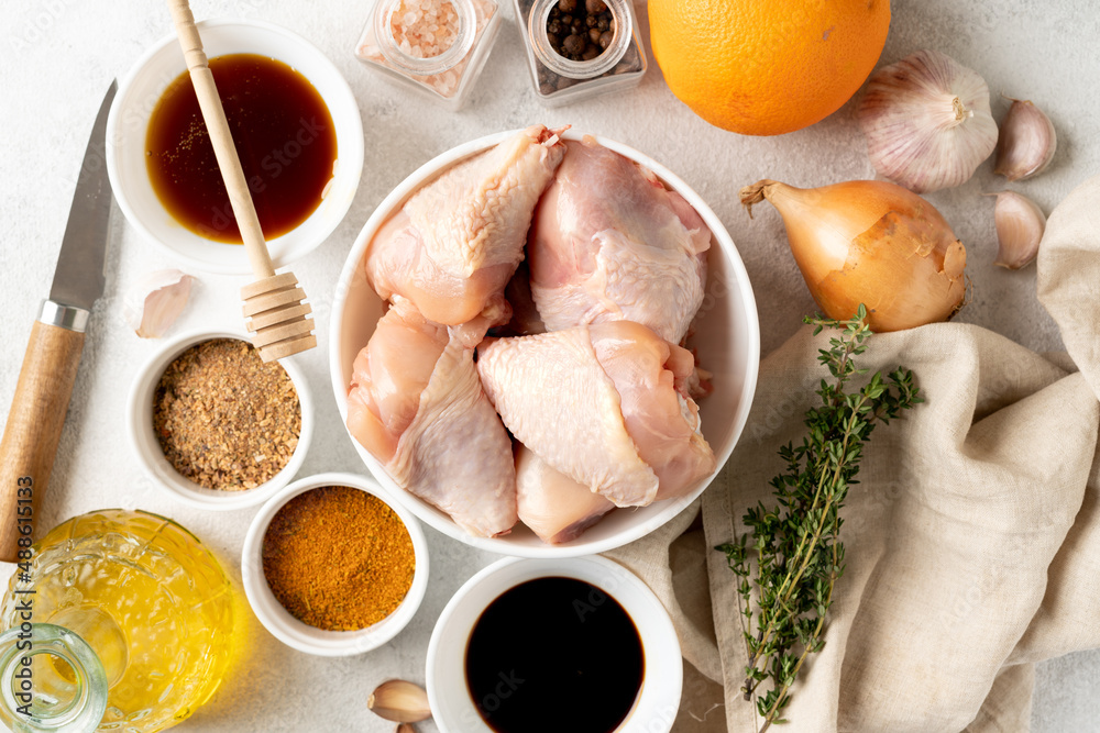 Raw chicken legs and spices on a light gray culinary background. Raw poultry meat and seasonings are prepared for pickling. Top view
Raw chicken legs and spices on a light gray culinary background. Raw poultry meat and seasonings are prepared for pickling. Top view