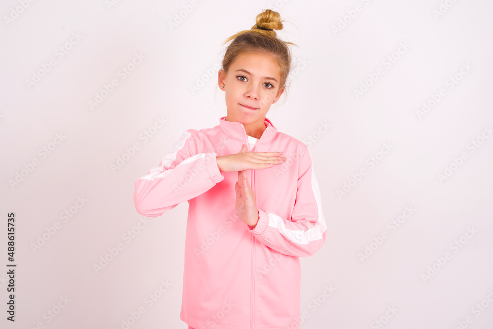 caucasian little kid girl with bun hairstyle wearing pink tracksuit ...