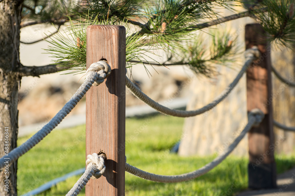 Handmade fence from hemp ropes in public park. Handmade fence from hemp ropes in public park.