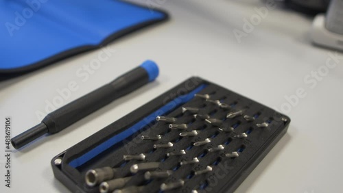Bit screwdriver set prepared for use on a blue mat