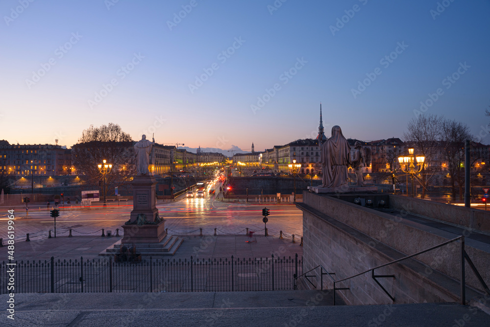 Fototapeta premium Turin, Italy. February 15, 2022. View at dusk from the starway of Gran Madre di Dio Church on the evening car traffic on Corso Casale and the Vittorio Emanuele I Bridge.