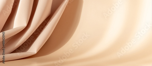 Foto Abstract 3d studio with draping silk fabric and shadow on cream beige pastel monochrome background for cosmetic product presentation