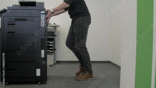 Technician dismantles a multifunction device.