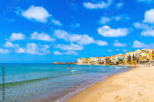 Fototapeta Naklejka Na Ścianę i Meble -  Sandy beach in Cefalu town, Sicily island, Italy. Cefalu has a long and lovely beach with clean, golden sand. Is one of the best in Sicily