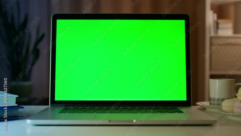 Mock-up green screen laptop on desk in modern apartment. Mock-up green screen laptop on desk in modern apartment.
