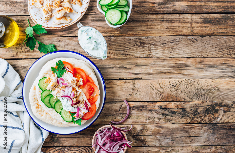 Healthy diet Gyros, greek pita bread wrapped sandwich with meat slices, tzatziki and fresh vegetables. Healthy diet Gyros, greek pita bread wrapped sandwich with meat slices, tzatziki and fresh vegetables.