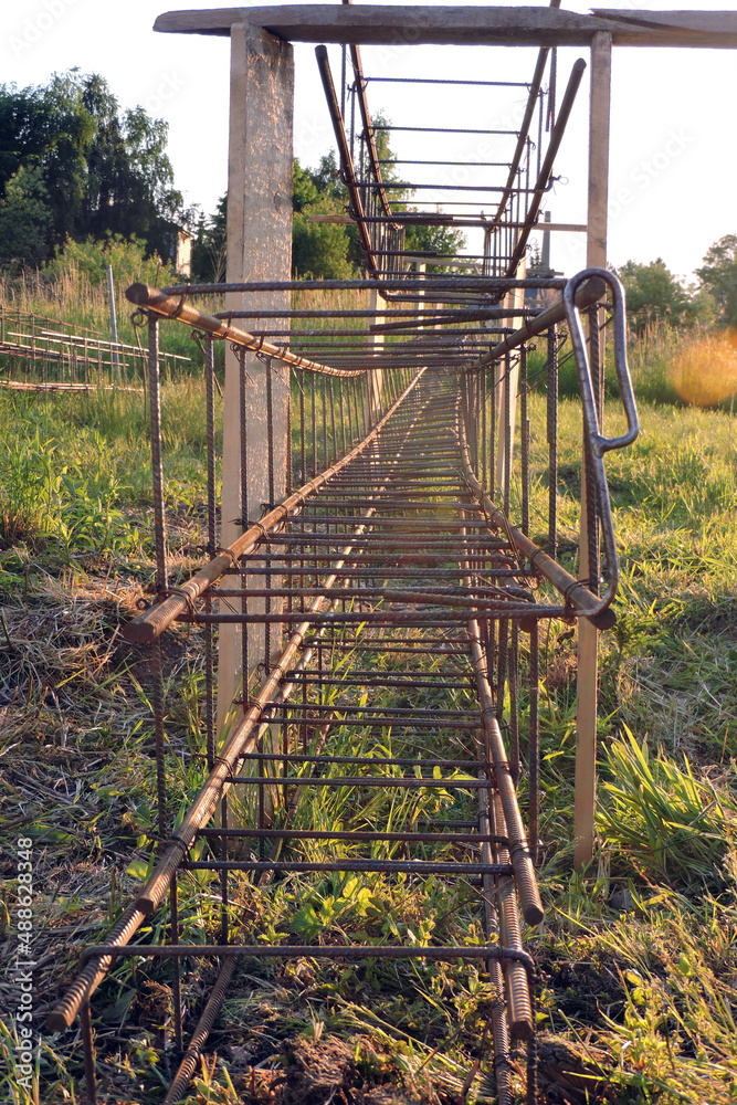 The steel rebar made of reinforcing bars and steel wires, green grass The steel rebar made of reinforcing bars and steel wires, green grass