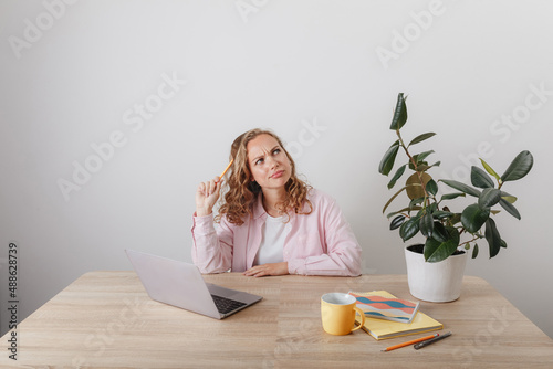 A young girl studies and works at home