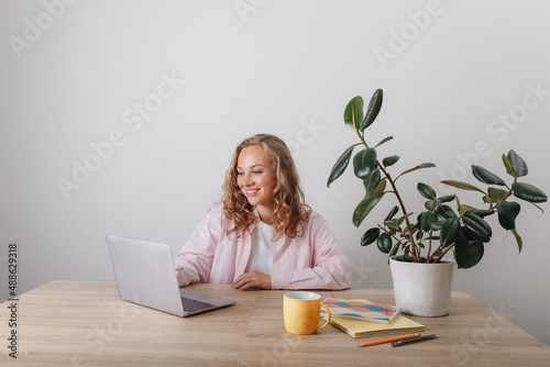 A young girl studies and works at home