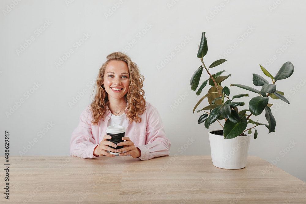 Young beautiful girl student drinks morning coffee Young beautiful girl student drinks morning coffee
