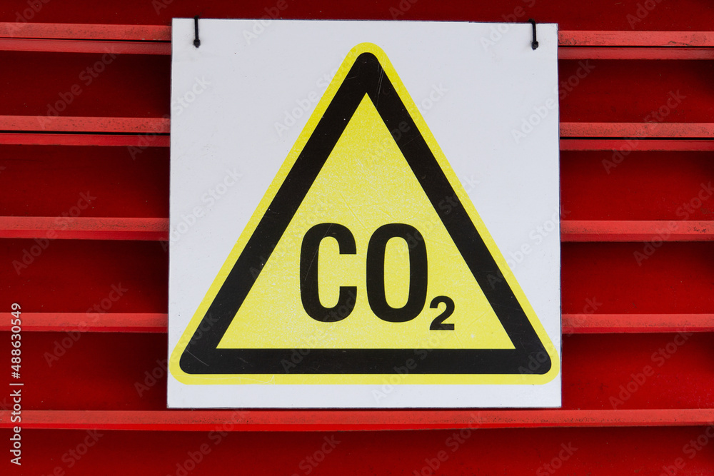 CO2 warning sign on a red background. Yellow triangle security labeled