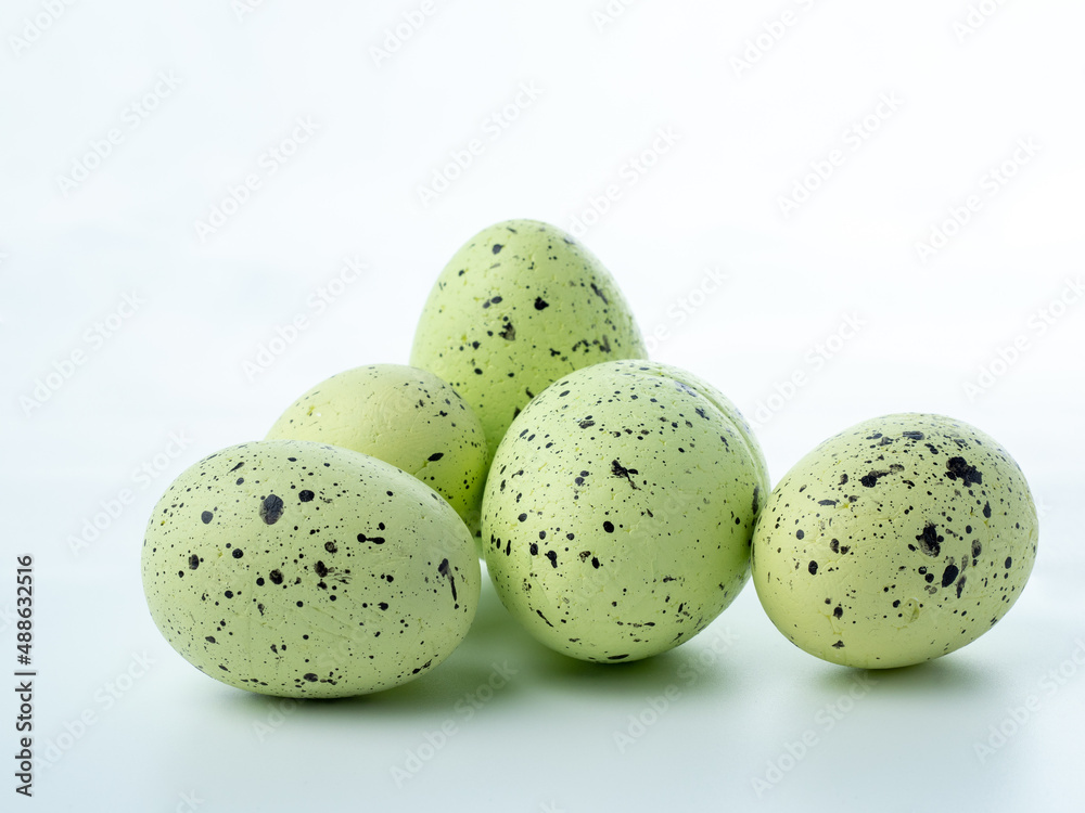 Close-up, colored styrofoam eggs on a white background.