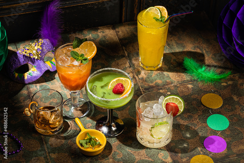 Photos Alcoholic cocktails, Mardi Gras decoration on dark background