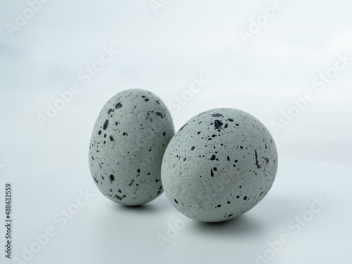 Close-up  colored styrofoam eggs on a white background.