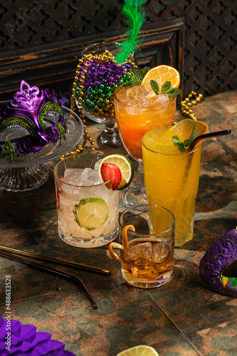 Alcoholic cocktails, Mardi Gras decoration on dark background