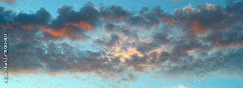Colorful dramatic sky with cloud at sunrise. Wide photo.