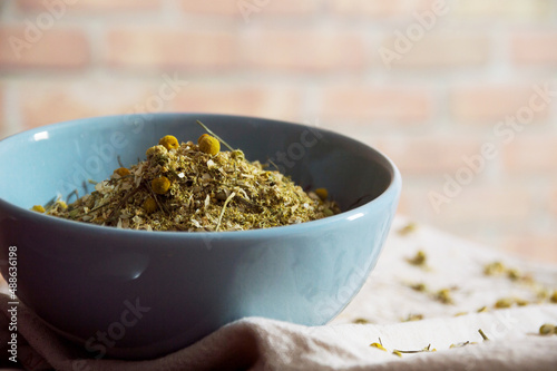 Dried chamomile inside a blue bowl