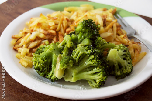 French fries and broccoli on white plate