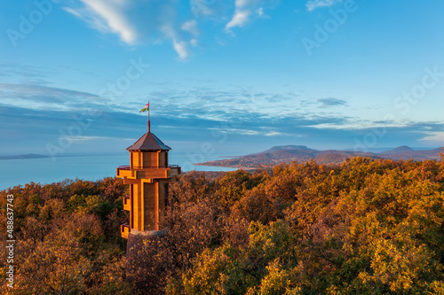 Aerial view about the freshly renovated lookout tower at Révfülöp. Lake Balaton, Badacsony and cloudy autumn sunrise at the background. Hungarian name is Fülöp-hegyi Millenniumi kilátó. photo