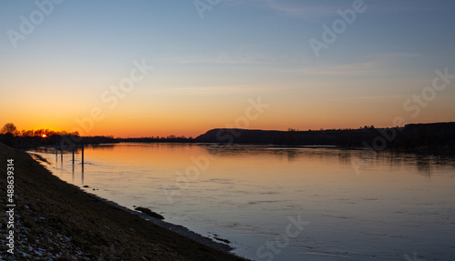 Sunset on the Wisla River. Vistula bank in Kazimierz Dolny. Yellow and blue sky