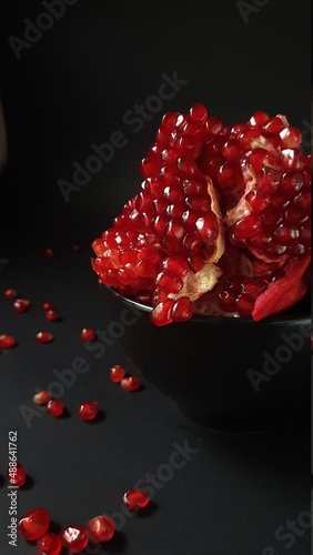 red pomegranate on black background