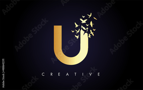 Golden U Logo Letter with Flock of Birds Flying and Disintegrating from the Letter.