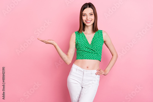 Photo of young pretty girl hold arm promo advertise recommend proposition isolated over pink color background