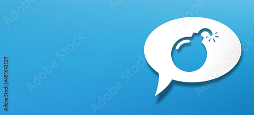 White speech bubble with cut out bomb shape over blue background 