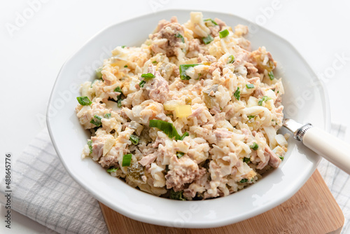Salad with rice, tuna, egg, pickled cucumber, and chives.