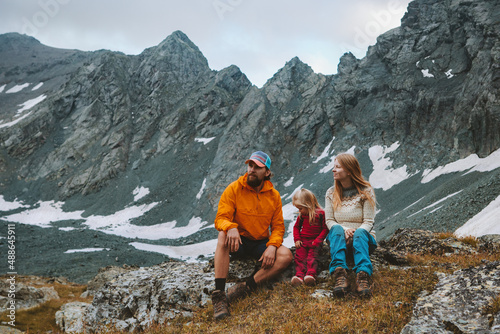 Family traveling relaxing in mountains summer vacations mother and father hiking with child camping outdoor adventure active healthy lifestyle eco tourism