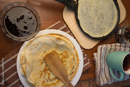 Pancake week. Preparation of dough for baking delicious and ruddy pancakes from the ingredients eggs, flour, butter and milk. Maslenitsa traditional Russian festival meal.
